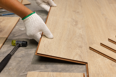 hands installing interlocking laminate floor