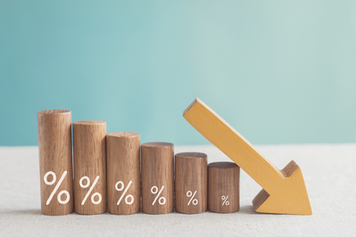wooden blocks with percentage signs and down arrow to show lower interest rates