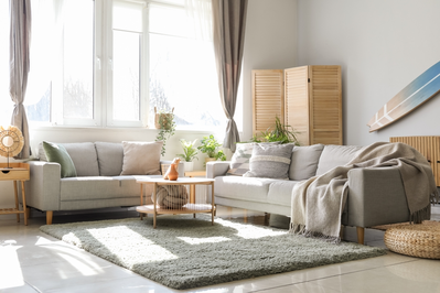 natural light in living room from large window with tied back curtains