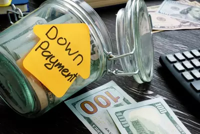 jar of cash labeled "Down Payment"