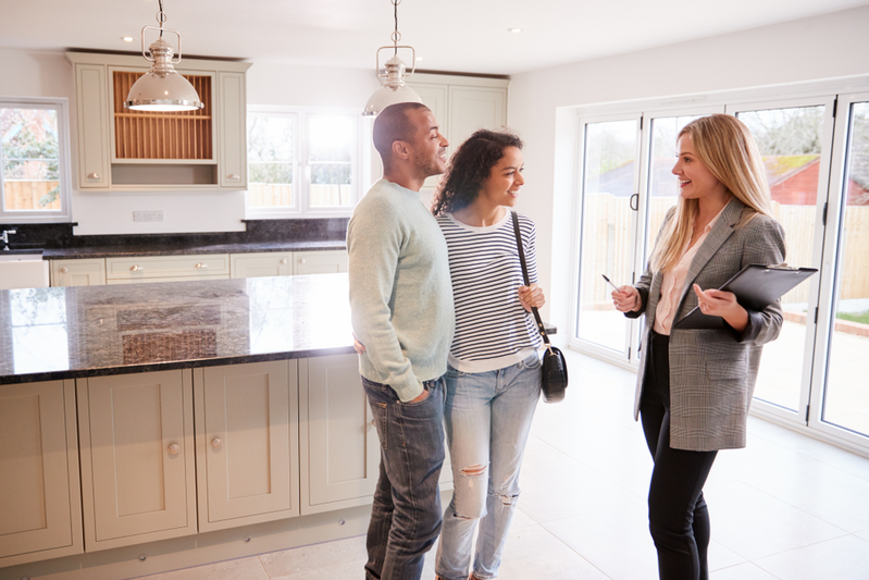 real estate agent showing couple a house