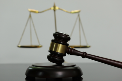 judge's hammer in front of scales of justice