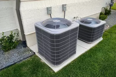 AC units outside of white brick home