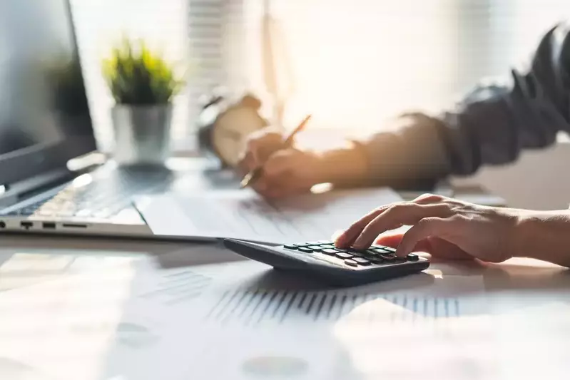 calculating taxes with calculator and pencil
