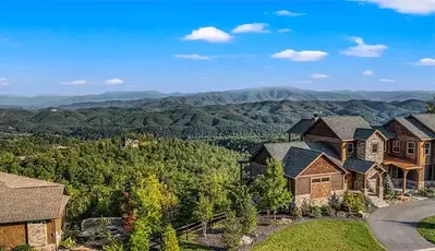 aerial view of cabins with mountain views