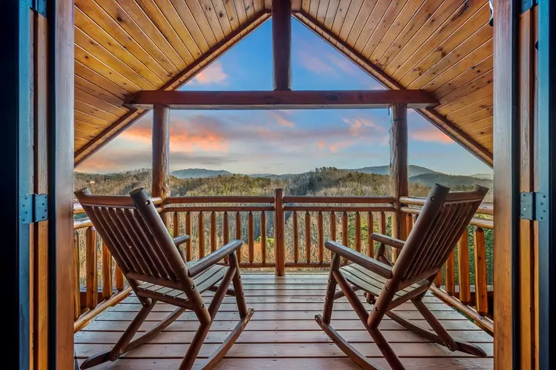 rocking chairs on deck with mountain view