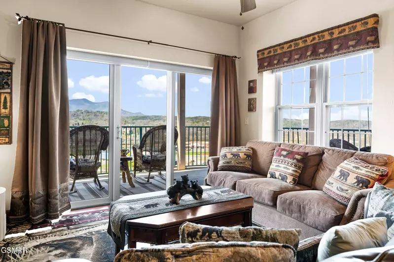 living room with balcony with mountain view