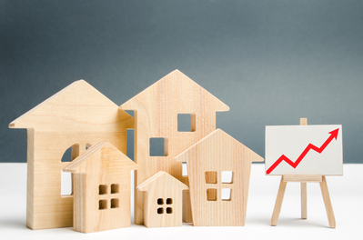 models of houses and upward trend chart