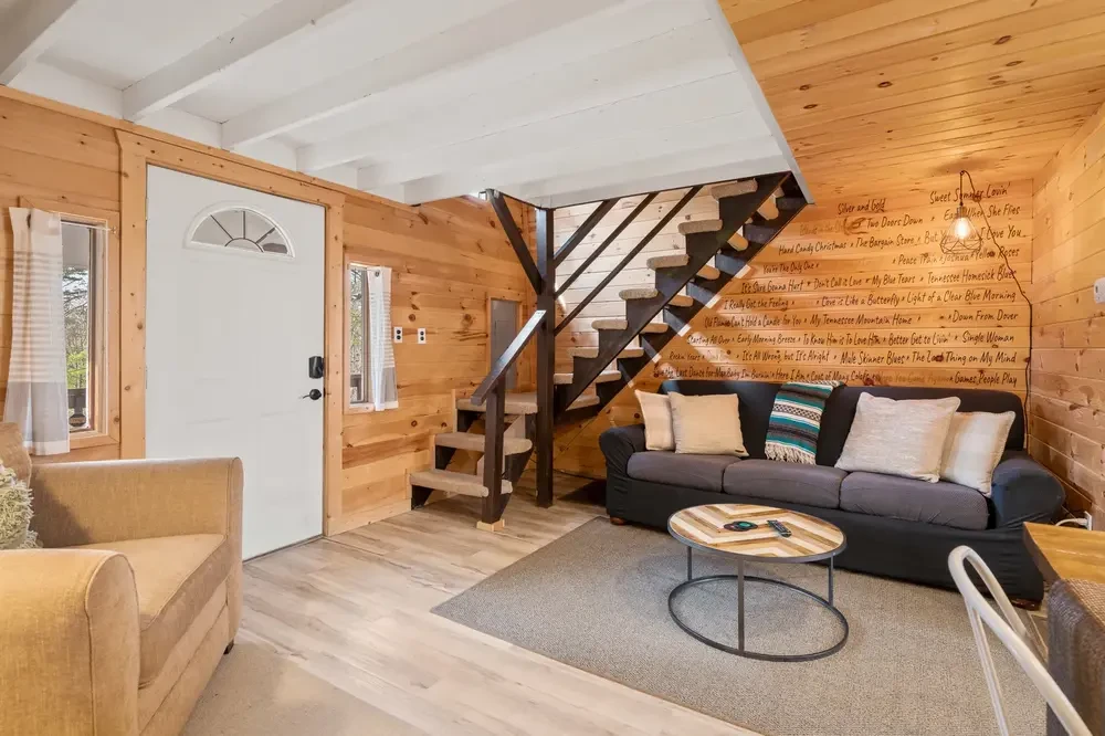 cabin living room with song titles on wall