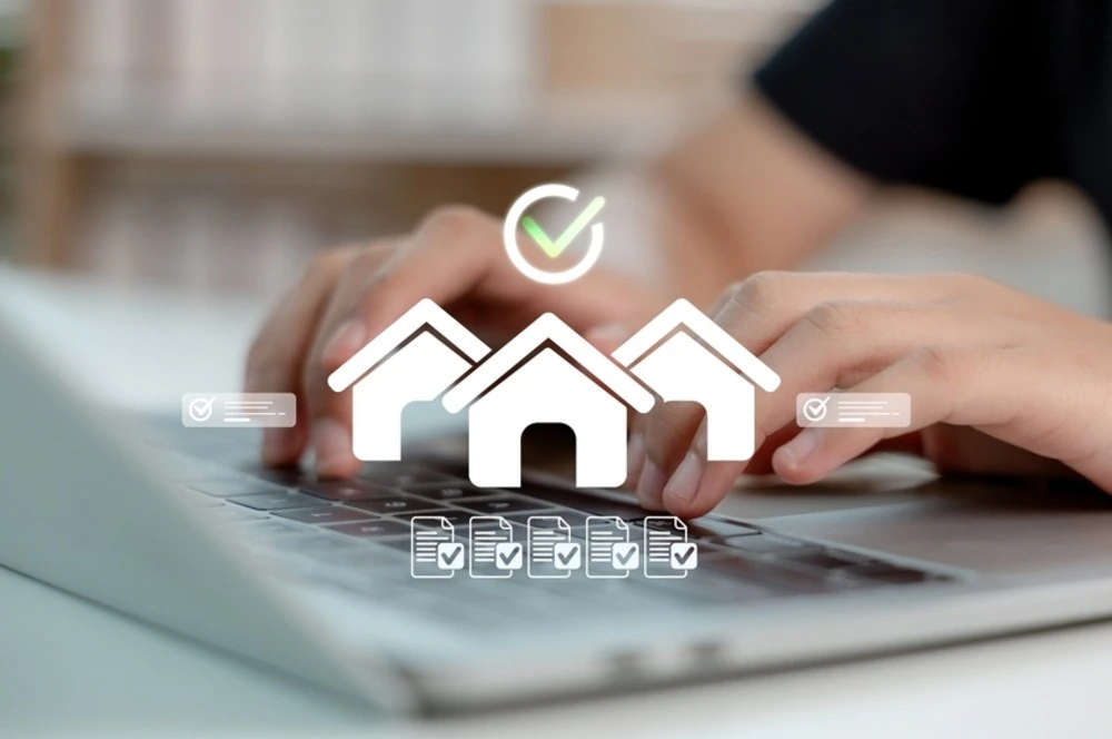 icons of houses and documents with check marks on laptop